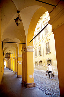 Arcade and cyclist, Modena, Emilia Romagna, Italy, Europe