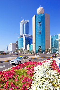 Contemporary architecture and taxi on Rashid Bin Saeed Al Maktoum Street, Abu Dhabi, United Arab Emirates, Middle East