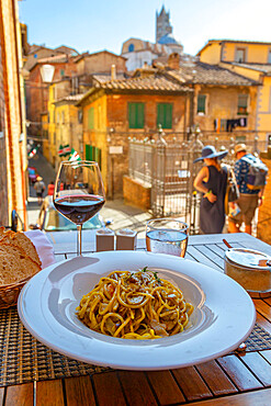 View of traditional Italian cuisine, pasta and wine, Siena, Tuscany, Italy, Europe