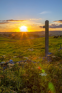 View of sunset, footpath sign and countryside near Wardlow, Peak District National Park, Derbyshire, England, United Kingdom, Europe