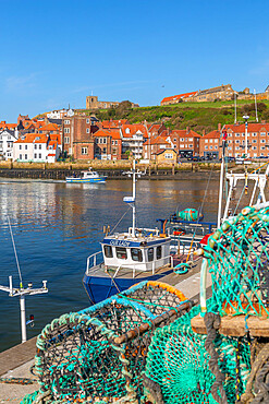 View of St. Mary's Church and fishing baskets, houses and boats on the River Esk, Whitby, Yorkshire, England, United Kingdom, Europe