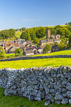 View of village church, cottages and dry stone walls, Hartington, Peak District National Park, Derbyshire, England, United Kingdom, Europe