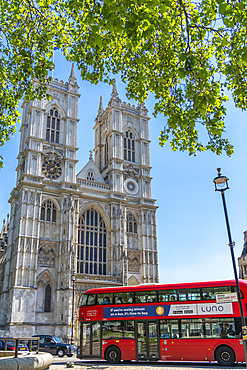 View of traditional red bus and Westminster Cathedral framed by green foliage, Westminster, London, England, United Kingdom, Europe