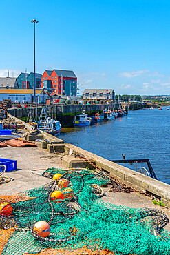 View of fishing nets on quayside and River Coquet at Amble, Morpeth, Northumberland, England, United Kingdom, Europe