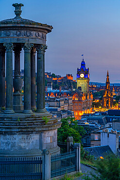 View of Edinburgh Castle, Balmoral Hotel and Dugald Stewart monument from Calton Hill at dusk, UNESCO World Heritage Site, Edinburgh, Lothian, Scotland, United Kingdom, Europe