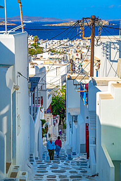 View of narrow street leading to town and sea, Mykonos Town, Mykonos, Cyclades Islands, Greek Islands, Aegean Sea, Greece, Europe