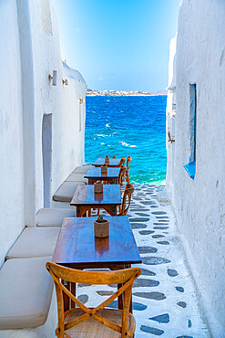 View of sea and restaurant tables in Mykonos Town, Mykonos, Cyclades Islands, Greek Islands, Aegean Sea, Greece, Europe