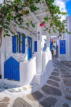 View of girl walking through whitewashed narrow street, Mykonos Town, Mykonos, Cyclades Islands, Greek Islands, Aegean Sea, Greece, Europe