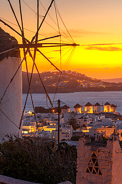 View of the windmills and town from elevated position at dusk, Mykonos Town, Mykonos, Cyclades Islands, Greek Islands, Aegean Sea, Greece, Europe