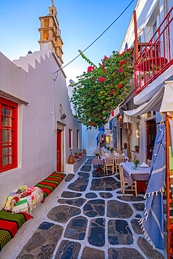 View of cafe in colourful narrow cobbled street, Mykonos Town, Mykonos, Cyclades Islands, Greek Islands, Aegean Sea, Greece, Europe