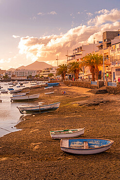 View of boats on beach in Baha de Arrecife Marina surrounded by shops, bars and restaurants at sunset, Arrecife, Lanzarote, Canary Islands, Spain, Atlantic, Europe