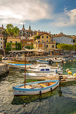 View of boats in the marina and harbourside restaurants during golden hour in Volosko, Opatija, Kvarner Bay, Croatia, Europe