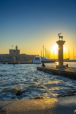 View of bronze stag and doe statues and Saint Nicholas Fortress at sunrise, City of Rhodes, Rhodes, Dodecanese Islands, Greek Islands, Greece, Europe