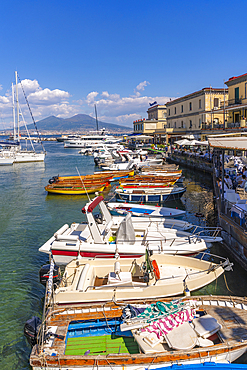 View of boats in harbour, restaurants and Mount Vesuvius from Ovo Castle, Naples, Campania, Italy, Europe