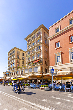 View of pastel coloured architecture, restaurants and cafes on seafront of Via Partenope, Naples, Campania, Italy, Europe