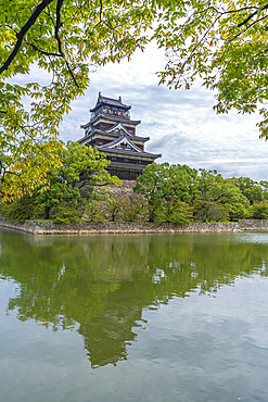 View of Hiroshima Castle, with museum, reflecting in Moat, Motomachi, Naka Ward, Hiroshima, Honshu, Japan