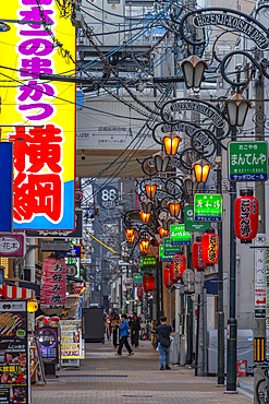 View of colourful signs in backstreet in Dotonbori, vibrant entertainment district near the river, Osaka, Honshu, Japan