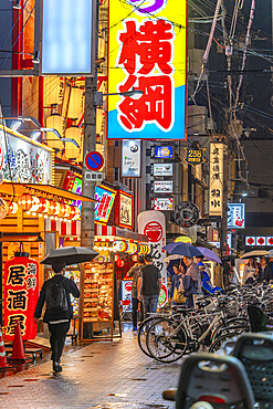 View of colourful signs in backstreet in Dotonbori, vibrant entertainment district near the river, Osaka, Honshu, Japan