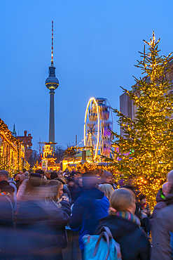 View of Christmas market stalls in Vorplatz Berliner Schloss at Christmas and Berlin TV Tower in background, Mitte, Berlin, Germany, Europe