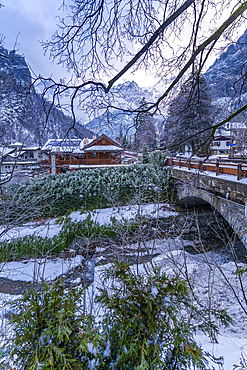 View of hotels and lodges with mountains in background during winter, Courmayeur, Aosta Valley, Italy, Europe