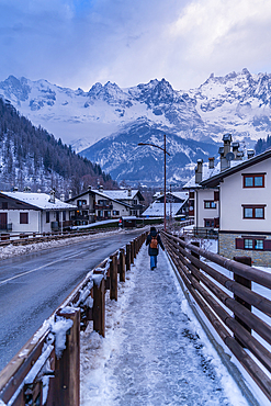 View of hotels and lodges with mountains in background during winter, Courmayeur, Aosta Valley, Italy, Europe