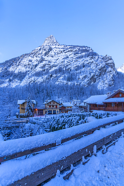 View of chalets and snow covered mountains in Courmayeur before dawn during winter, Courmayeur, Aosta Valley, Italy, Europe