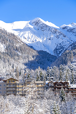 View of snow covered trees, mountains and Courmayeur from Dolonne during winter, Courmayeur, Aosta Valley, Italy, Europe