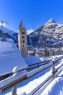 View of snow covered mountains, rooftops and Church of Saint Pantalon in Courmayeur during winter, Courmayeur, Aosta Valley, Italy, Europe