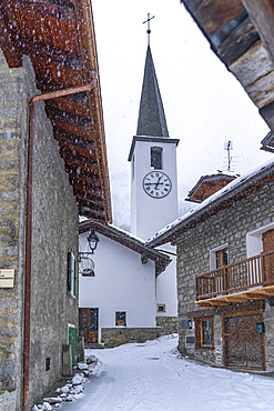 View of snow covered wooden houses and church in Entrèves during winter, Entrèves, Aosta Valley, Italy, Europe