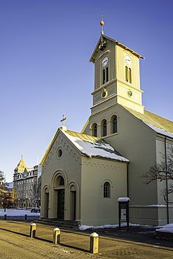 View of Reykjavik Cathedral from Austurvollur park and gardens on a sunny day in winter, Reykjavik, Iceland