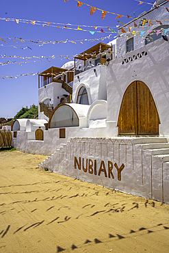 View of colourful architecture at Nagaa Suhayl Gharb on the Nile river near Aswan, Aswan, Nubia, Egypt, North Africa, Africa