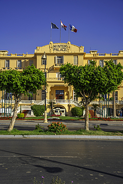 View of the Winter Palace Hotel on the corniche in Luxor on a sunny day, Luxor, Egypt, Africa