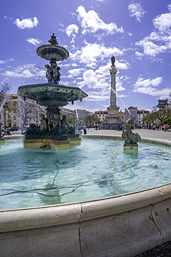 View of North fountain of Rossio in Praca do Rossio on a sunny day in Lisbon city centre, Lisbon, Portugal, Europe