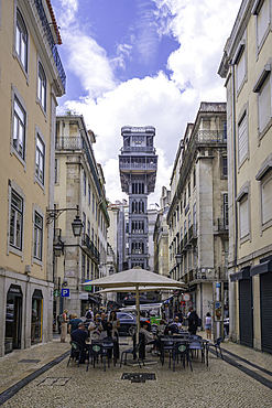 View of Santa Justa Lift and street cafe on a sunny day, Lisbon, Portugal, Europe