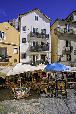 View of colourful buildings and cafe in the Alfama District on a sunny day, Lisbon, Portugal, Europe