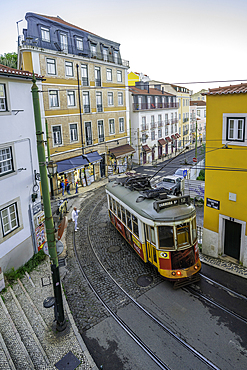 View of vintage tram and colourful buildings in the Alfama District on a sunny day, Lisbon, Portugal, Europe