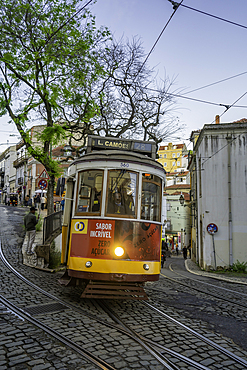 View of vintage tram and colourful buildings in the Alfama District on a sunny day, Lisbon, Portugal, Europe
