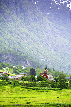 View of Olden New Church in Olden village and mountains in Nordfjorden during summer, Norway, Scandinavia, Europe