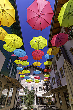 View of colourful umbrellas in Zell am See on a sunny day, Zell am See, Salzburg, Austria, Europe