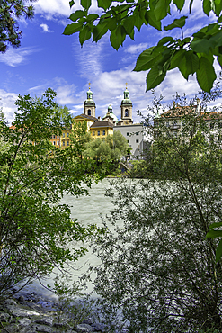 View of St. Jakob Cathedral, colourful buildings and River Inn on a sunny day in summer, Innsbruck, Tyrol Region, Austria, Europe