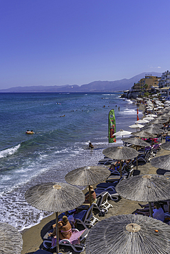 View of sunshades on Limena Chersonisou Beach, Limenas Chersonisou, Crete, Greek Islands, Greece, Europe