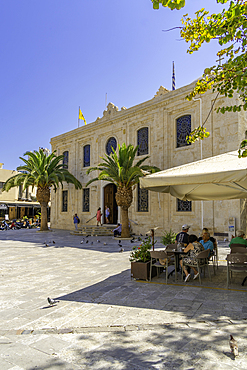 View of Cathedral Holy Temple of Saint Titus and cafe on a sunny day, City of Heraklion, Crete, Greek Islands, Geece, Europe