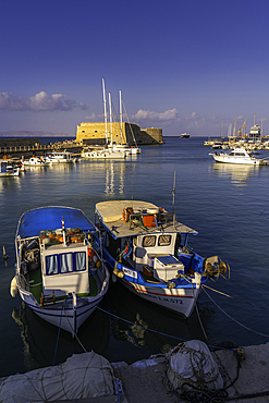 View of Koules Venetian Fortress and boats in Heraklion Venetian Port at sunset, City of Heraklion, Crete, Greek Islands, Geece, Europe