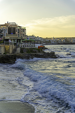 View of taverna overlooking the sea in Limenas Chersonisou at sunset, Crete, Greek Islands, Greece, Europe