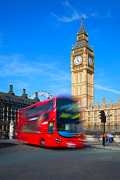 Motion blurred red London bus below Big Ben, Parliament Square, Westminster, London, England, United Kingdom, Europe