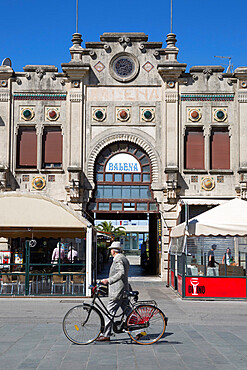 Suited man and bicycle walking past Art Nouveau buildings, Viale Regina Margherita, Viareggio, Tuscany, Italy, Europe