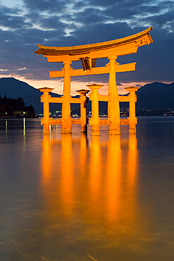 The floating Miyajima torii gate of Itsukushima Shrine at dusk, UNESCO World Heritage Site, Miyajima Island, Western Honshu, Japan, Asia