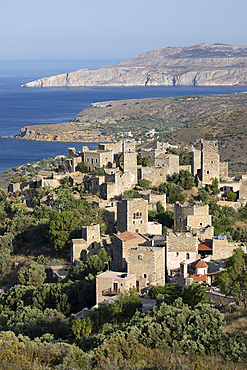View over traditional tower houses and Mani coastline behind, Vathia, Mani, Peloponnese, Greece, Europe