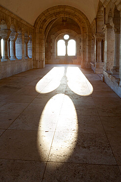 Sunlight pouring through arched windows, Fishermen's Bastion (Halaszbastya), Buda, Budapest, Hungary, Europe