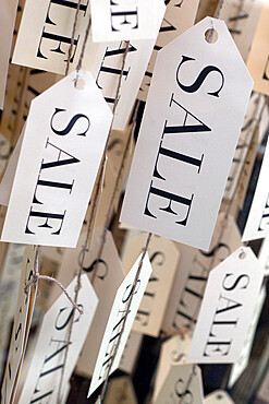 Sale tags in shop window, United Kingdom, Europe